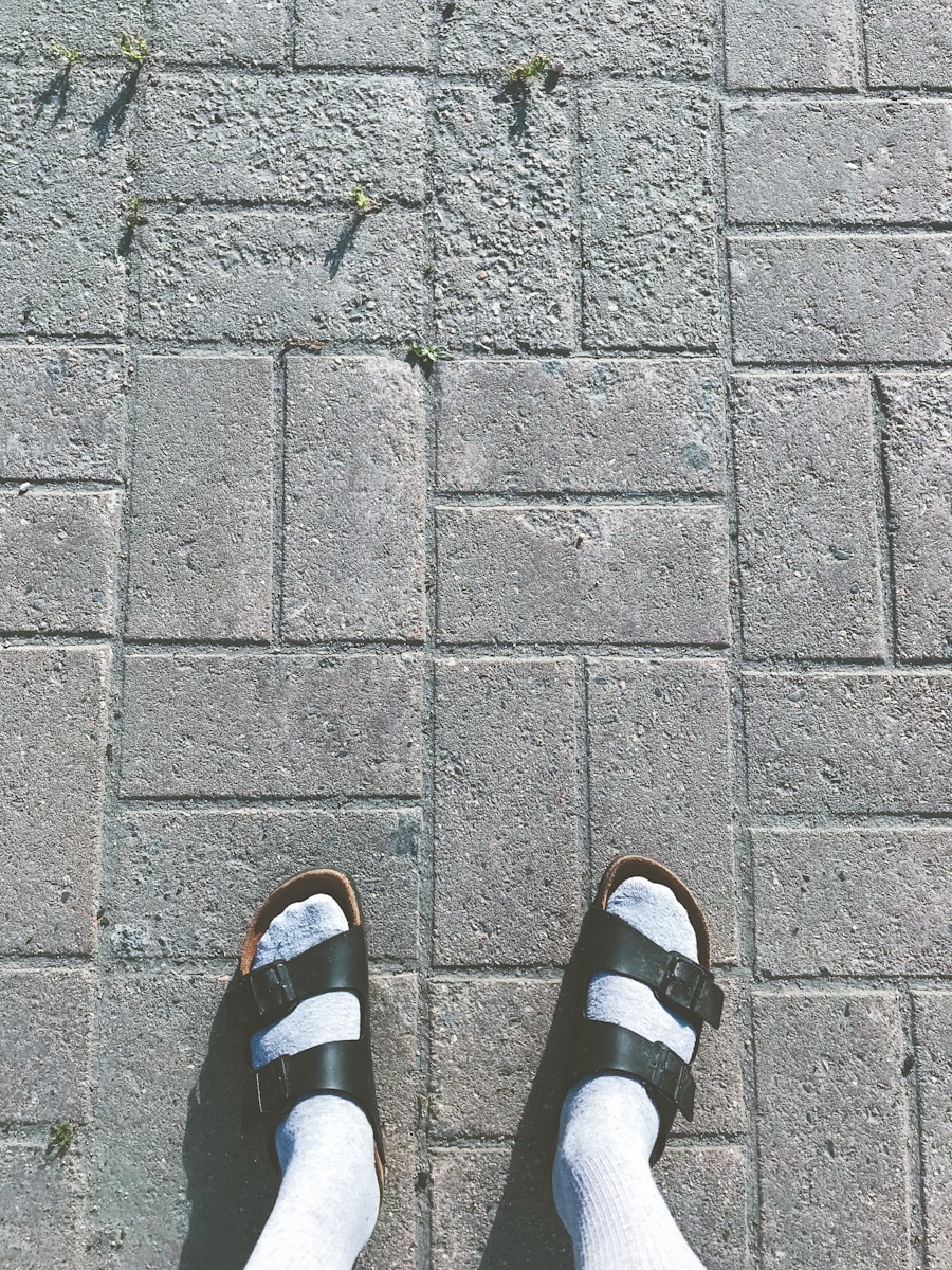 person wearing black and white slide sandals